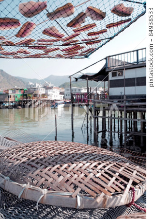 Vertical traditional Hong Kong old wooden house, sun dried fish, boat and river in countryside Vertical traditional Hong Kong old wooden house, sun dried fish, boat and river in countryside 84938533