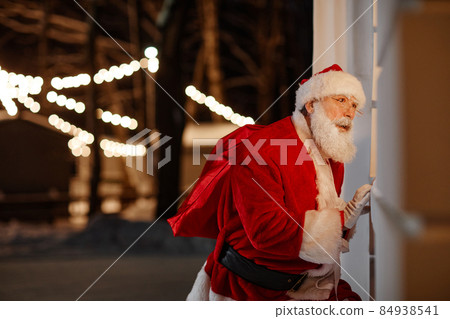 Curious Santa Peeping Through Window Curious Santa Peeping Through Window 84938541