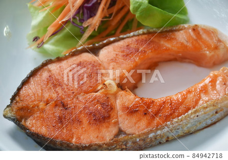grilled salmon steak dipping teriyaki sauce with fresh vegetable salad on plate grilled salmon steak dipping teriyaki sauce with fresh vegetable salad on plate 84942718
