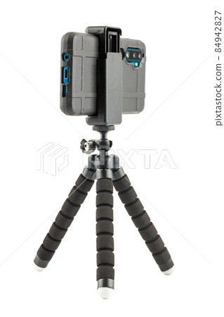 black cellphone in rugged rubber protective cover on small flexible tripod isolated on white black cellphone in rugged rubber protective cover on small flexible tripod isolated on white 84942827