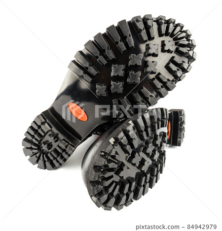 close-up wide angle view of new boots mini lugs black rubber outsole with 120 plus oil resistance grade , isolated on white 84942979