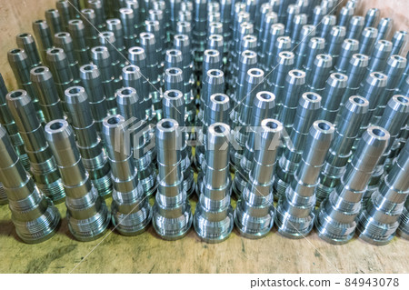 Shiny long steel parts background, clean steel rods after fine cnc turning. 84943078