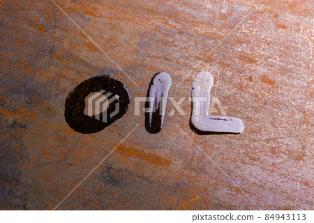 handwritten word oil on rusted sheet metal surface - close-up with selective focus 84943113