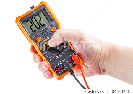 digit 2021 on lcd screen of digital electrical multimeter in left hand, isolated on white background digit 2021 on lcd screen of digital electrical multimeter in left hand, isolated on white background 84943206