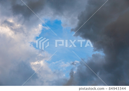 natural blue sky window in clouds, round gap in solid summer clouds natural blue sky window in clouds, round gap in solid summer clouds 84943344