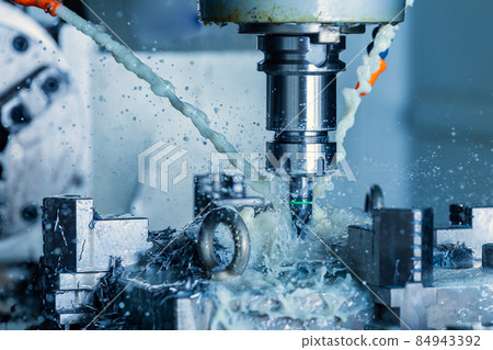 vertical cnc steel milling process with external water coolant streams, splashes and a lot of metal chips, high contrast 84943392