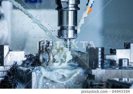 vertical cnc steel milling process with external water coolant streams, splashes and a lot of metal chips, high contrast 84943394