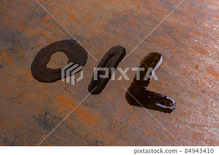 handwritten word oil on rusted sheet metal surface - close-up with selective focus 84943410