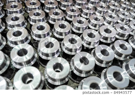 batch of shiny round steel parts background, close-up with selective focus and blur 84943577