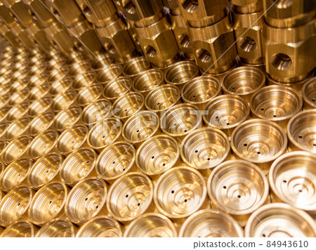 shiny brass metal threaded hexagonal fitting parts, abstract perspective industrial close-up background 84943610