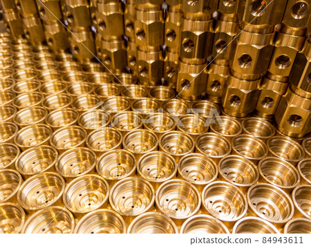 shiny brass metal threaded hexagonal fitting parts, abstract perspective industrial close-up background shiny brass metal threaded hexagonal fitting parts, abstract perspective industrial close-up background 84943611