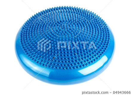 Blue inflatable balance disk isoleated on white background, It is also known as a stability disc, wobble disc, and balance cushion. 84943666