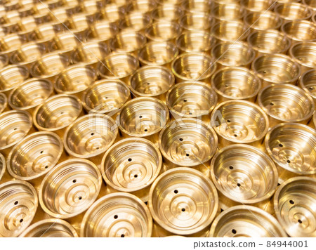 an abstract perspective industrial close-up background of shiny brass metal threaded hexagonal fitting parts an abstract perspective industrial close-up background of shiny brass metal threaded hexagonal fitting parts 84944001
