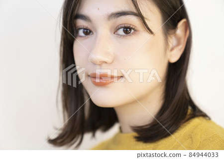 Portrait of a woman in a yellow knit Portrait of a woman in a yellow knit 84944033