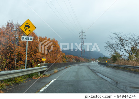 Highway scenery on a rainy day seen from the passenger seat Highway scenery on a rainy day seen from the passenger seat 84944274