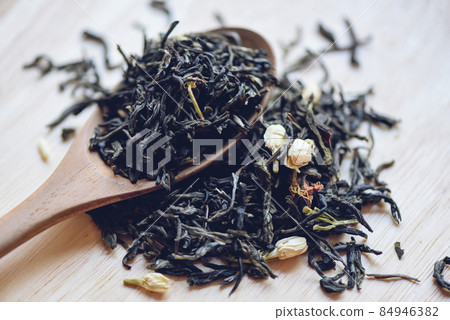 Chinese dry tea on wooden spoon, jasmine tea dried for brew tea, leaf black tea Chinese dry tea on wooden spoon, jasmine tea dried for brew tea, leaf black tea 84946382