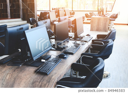 Group of computer with monitor neatly placed in a computer lab, computer room in the office modern with windows Group of computer with monitor neatly placed in a computer lab, computer room in the office modern with windows 84946383