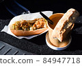 Street food. A cup of soup and a sandwich. 84947718