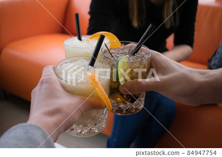People drinking cocktails. Cocktail cheers People drinking cocktails. Cocktail cheers 84947754