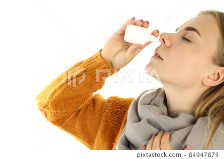 Young woman with nasal spray isolated on white background 84947873
