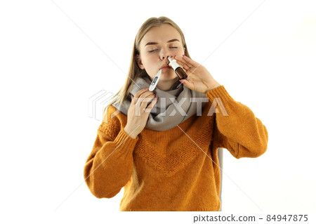 Young woman with nasal spray isolated on white background 84947875