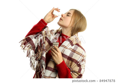 Young woman with nasal spray isolated on white background 84947878