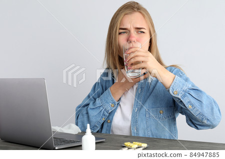 Ill young woman sitting on workplace, seasonal cold concept Ill young woman sitting on workplace, seasonal cold concept 84947885