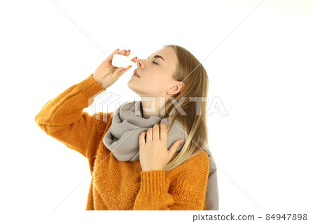 Young woman with nasal spray isolated on white background 84947898