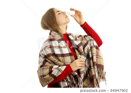 Young woman with nasal spray isolated on white background 84947902