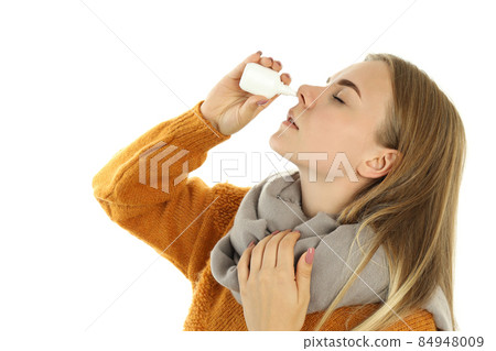 Young woman with nasal spray isolated on white background 84948009