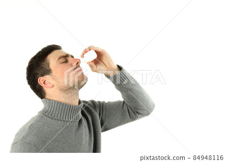 Young man with nasal spray isolated on white background 84948116