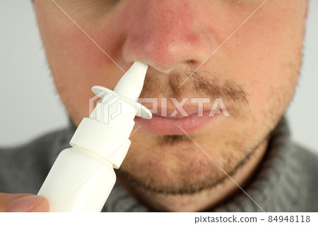 Young man use nasal spray, close up 84948118