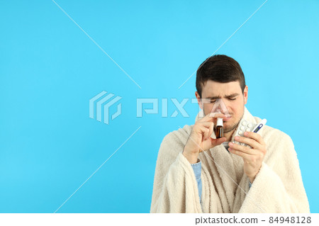 Ill young man on blue background, seasonal cold concept 84948128