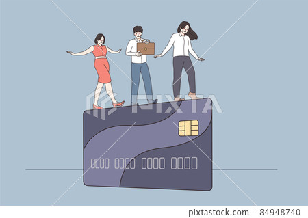 Businesspeople walk on edge of credit card Businesspeople walk on edge of credit card 84948740