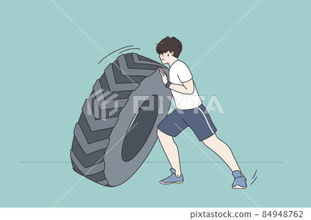 Sportsman push tire training in gym 84948762