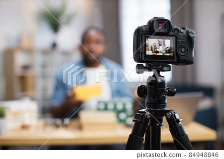 Blogger filming video while unpacking gift boxes at home Blogger filming video while unpacking gift boxes at home 84948846