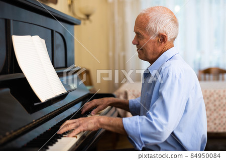 Compositor creating new music with piano at home 84950084