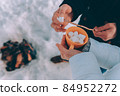 man stringing marshmallow on stick. winter theme 84952272