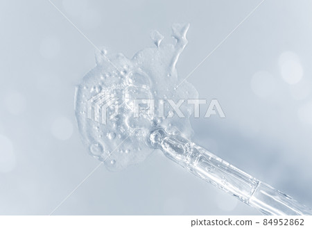 Pipette with fluid hyaluronic acid on gray background. Cosmetics and healthcare concept closeup. Dose of serum or retinol with air bubbles. Flat lay. Luxury gel or beauty product presentation in macro Pipette with fluid hyaluronic acid on gray background. Cosmetics and healthcare concept closeup. Dose of serum or retinol with air bubbles. Flat lay. Luxury gel or beauty product presentation in macro 84952862