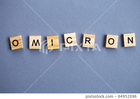 word omicron made by wooden blocks on gray background. word omicron made by wooden blocks on gray background. 84952896