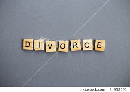 inscription divorce made by wooden blocks on gray background. broken family concept inscription divorce made by wooden blocks on gray background. broken family concept 84952901