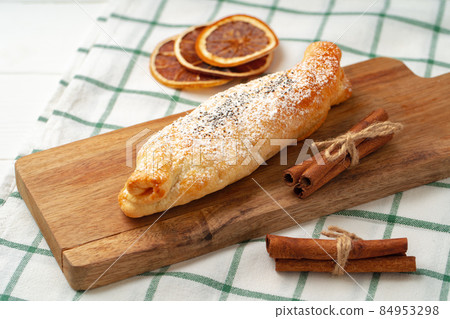 Traditional apple strudel on wooden board, close up Traditional apple strudel on wooden board, close up 84953298