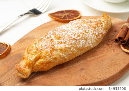 Traditional apple strudel on wooden board, close up Traditional apple strudel on wooden board, close up 84953308