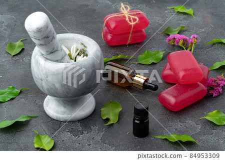 Composition with hand made soap bars and mortar on dark gray surface Composition with hand made soap bars and mortar on dark gray surface 84953309