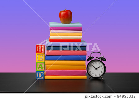 Stack of books on black wooden table 84953332