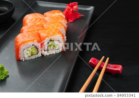 Fresh philadelphia sushi roll served on black plate Fresh philadelphia sushi roll served on black plate 84953341