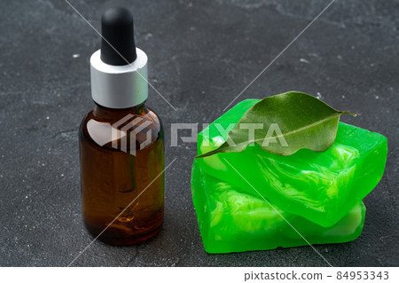 Bottle of eucalyptus essential oil and soap bars on black background 84953343