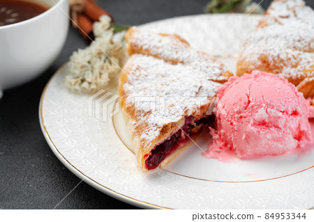 Classic shtrudel dessert with ice cream on white plate 84953344