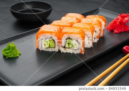 Fresh philadelphia sushi roll served on black plate 84953349