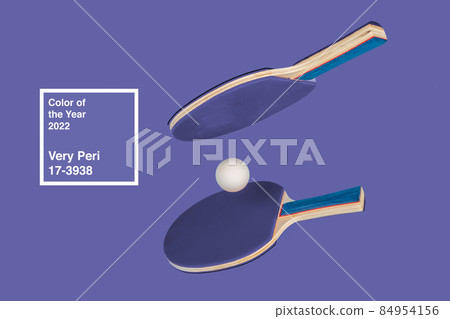 Purple ping pong racket on a purple background 84954156